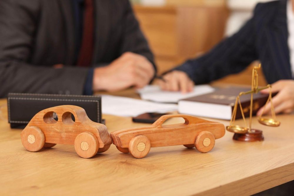 a wooden toy car sitting on top of a wooden table