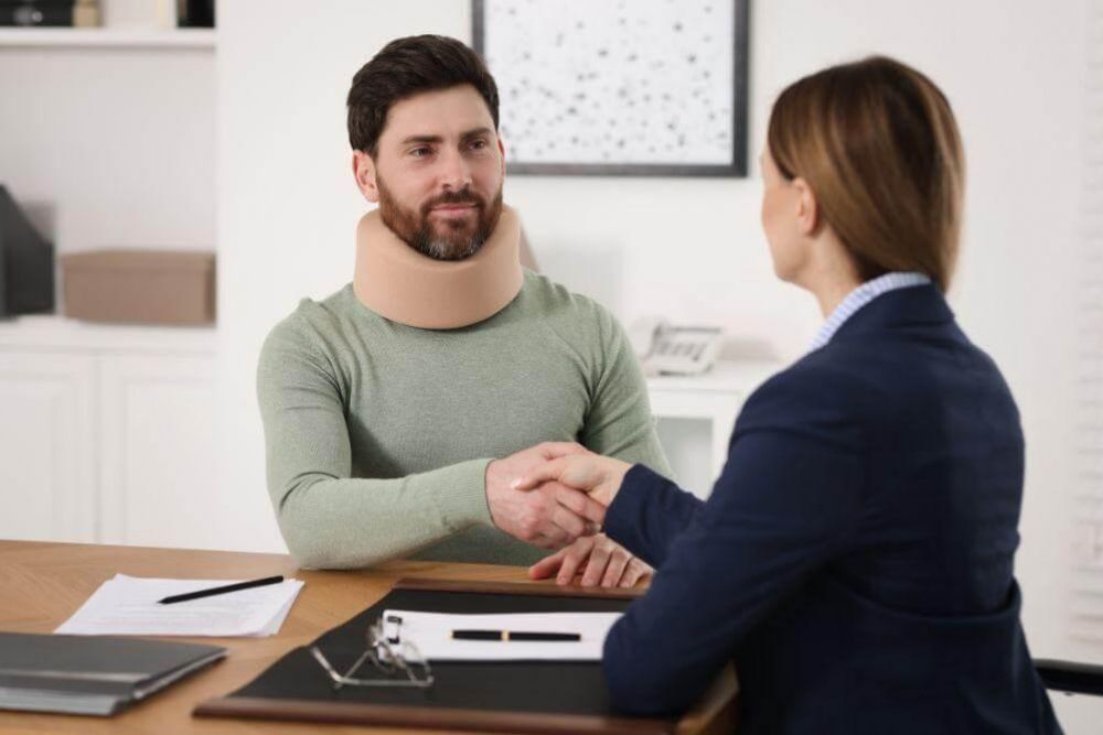 Woman shaking hands with her car accident lawyer in