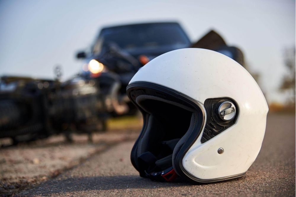 a white helmet sitting on the side of a road