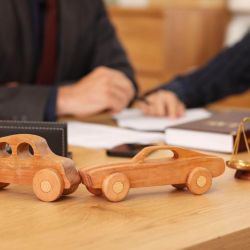 a wooden toy car sitting on top of a wooden table