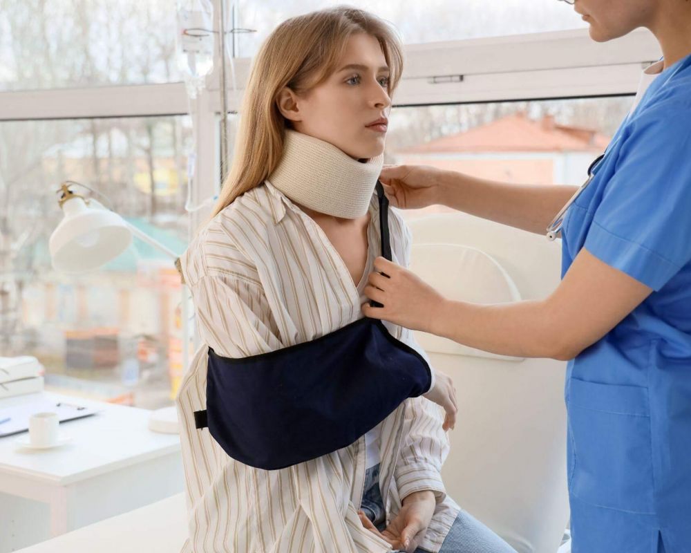 a woman with a cast on her neck is being assisted by a nurse