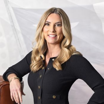 Jennifer LeMaster​ smiling confidently in a black sweater, posed against a light background.