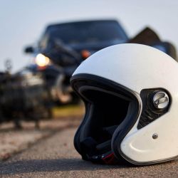 a white helmet sitting on the side of a road