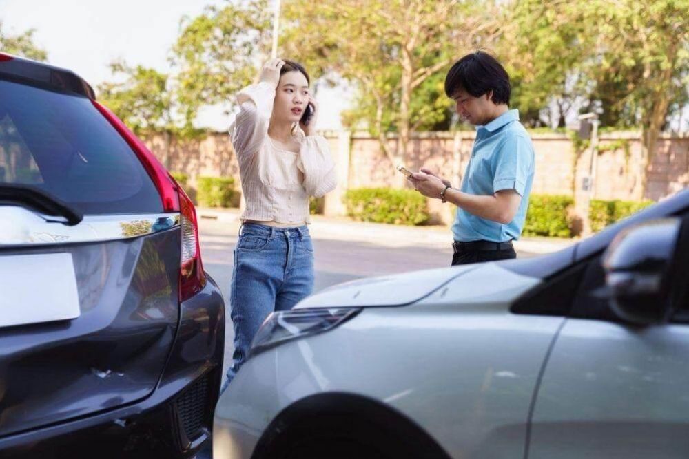 A couple reviewing their parked car after a rideshare