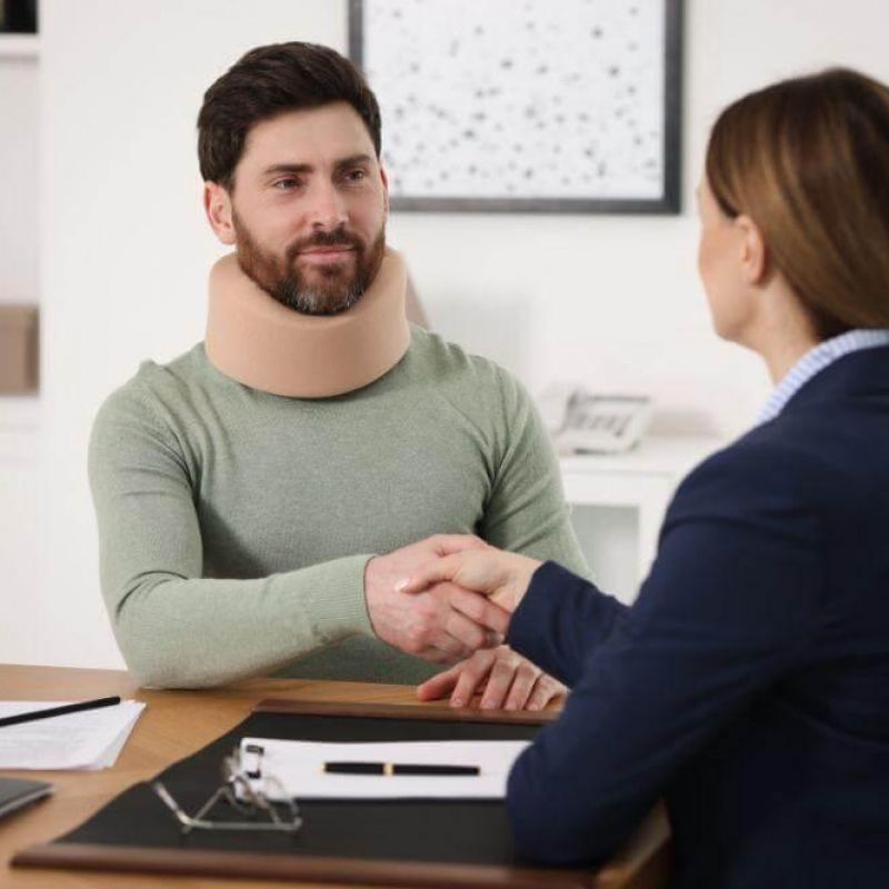 Woman shaking hands with her car accident lawyer in