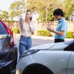 A couple reviewing their parked car after a rideshare