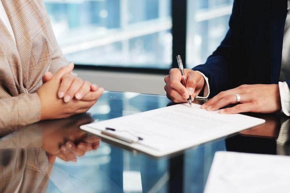 People reviewing documents for wrongful death settlements