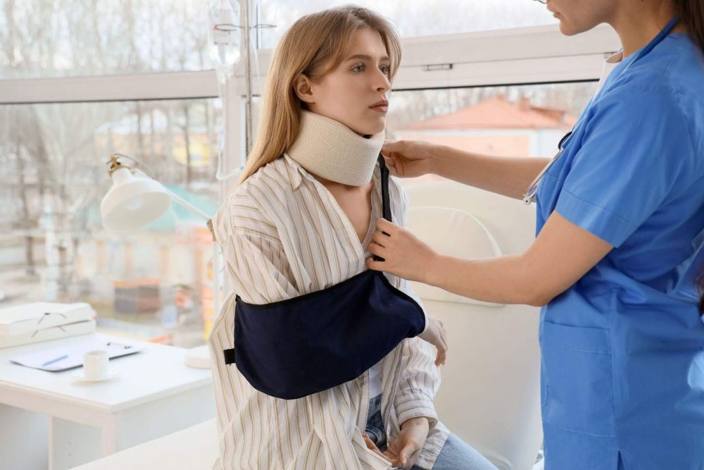 a woman with a cast on her neck is being assisted by a nurse
