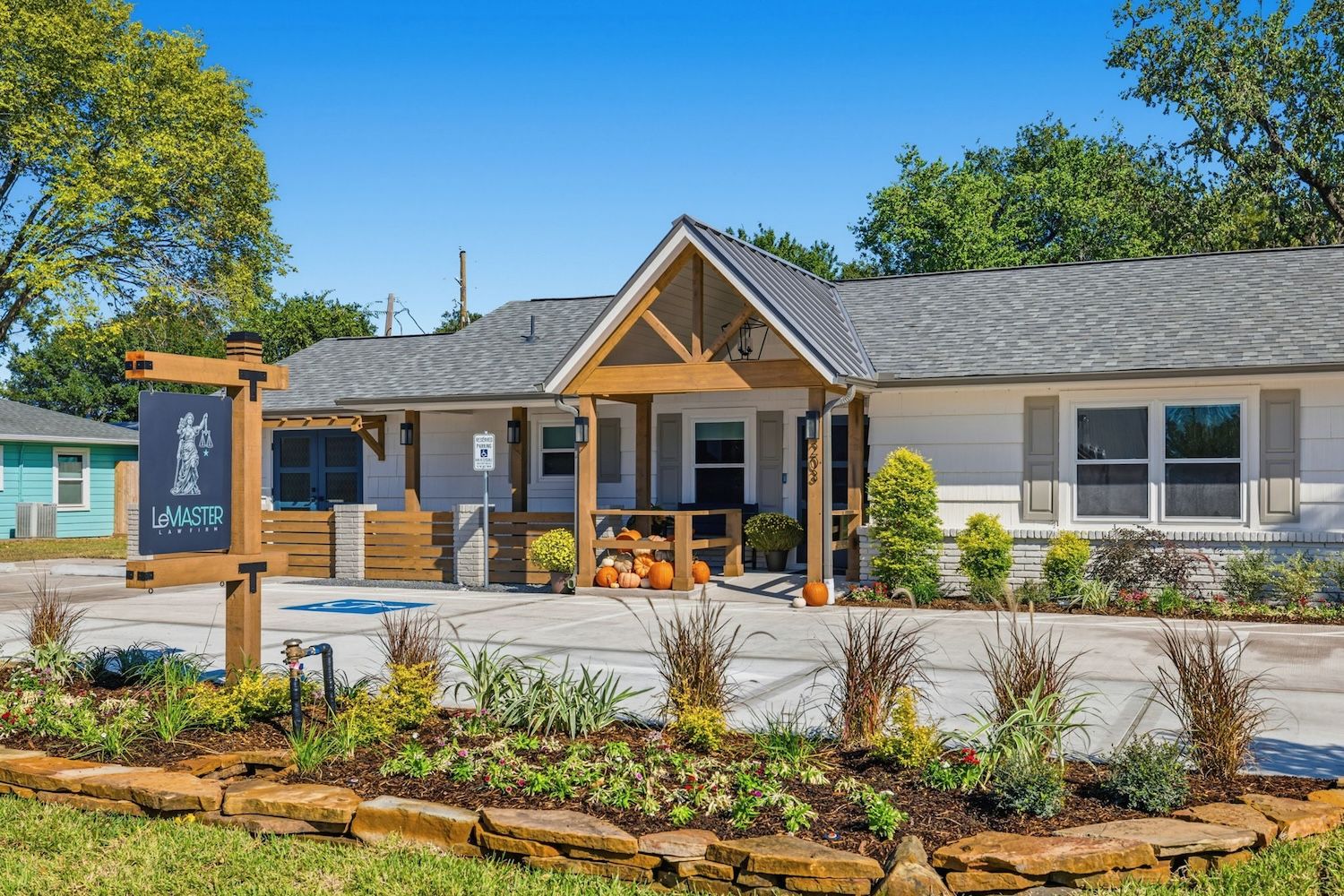 Single-story house with a spacious front yard and modern design under a clear blue sky.