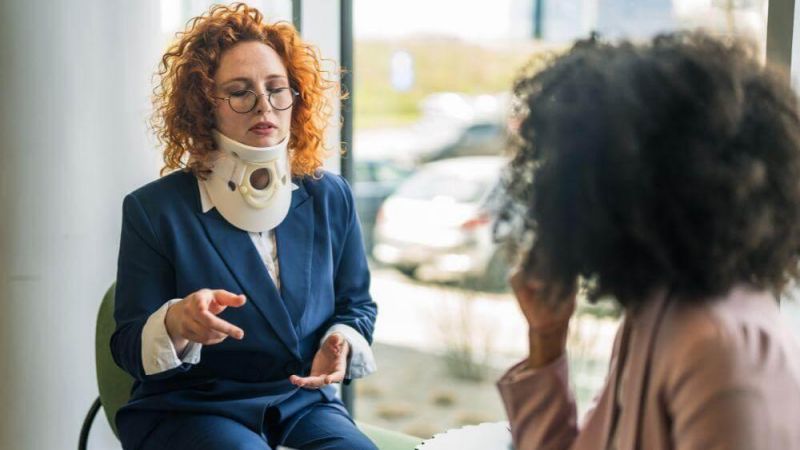 Woman with neck cast talking during a