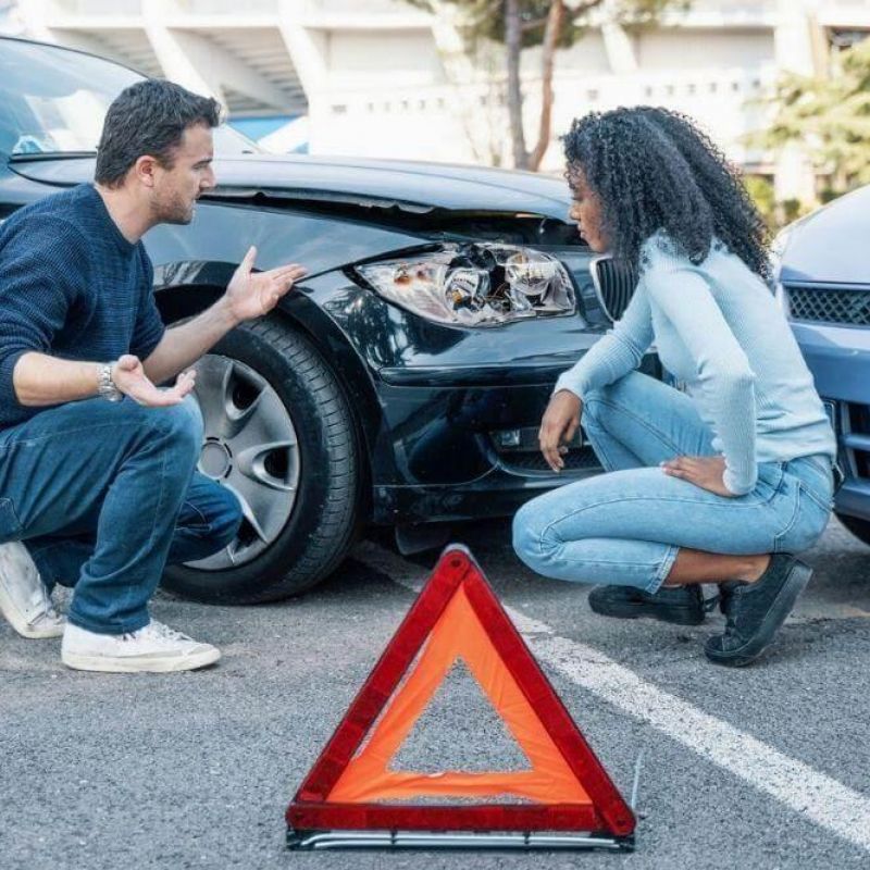 Man kneeling next to woman at the scene of