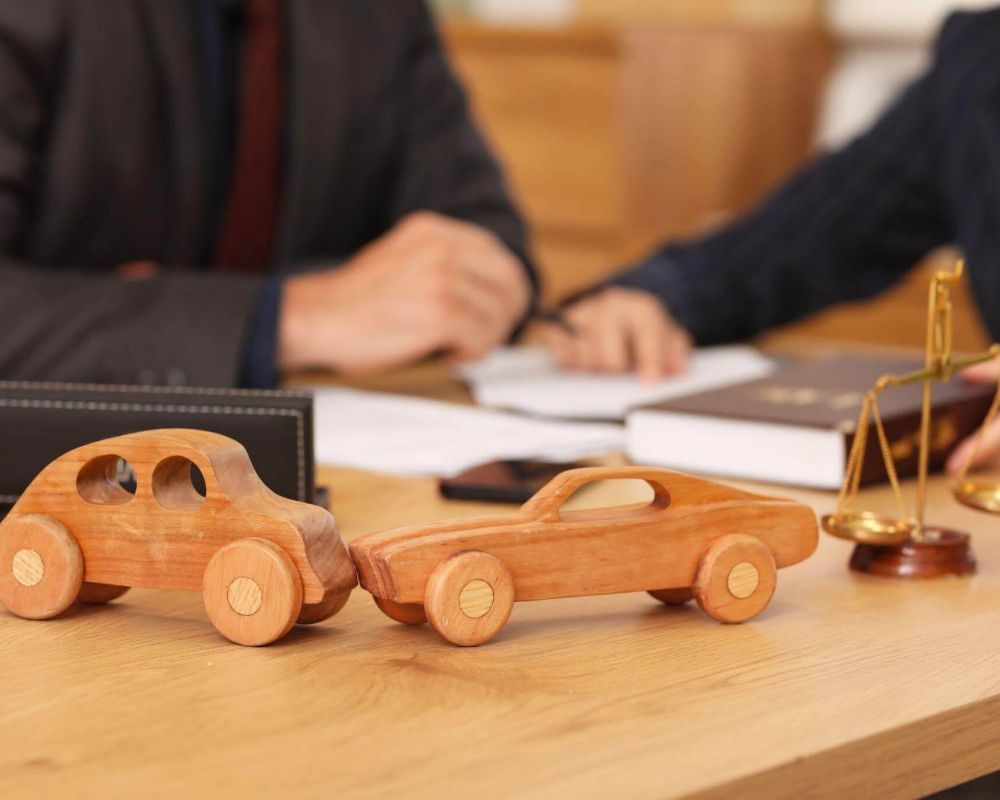 a wooden toy car sitting on top of a wooden table