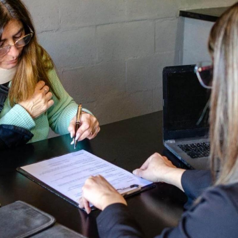 Two women reviewing documents related to a personal injury lawsuit
