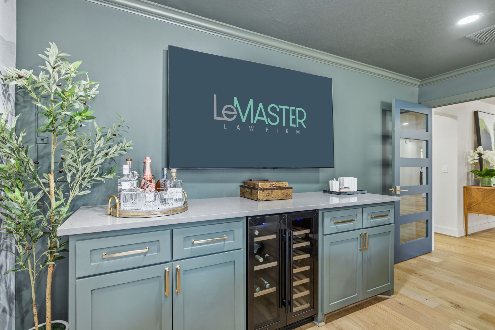 Legal office reception with elegant cabinetry, beverage station, and decorative accents.