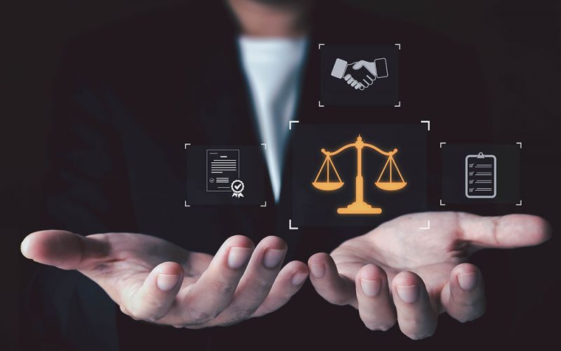 Businessman holding legal scales, contract, handshake, and checklist icons illustrating justice and business agreements.