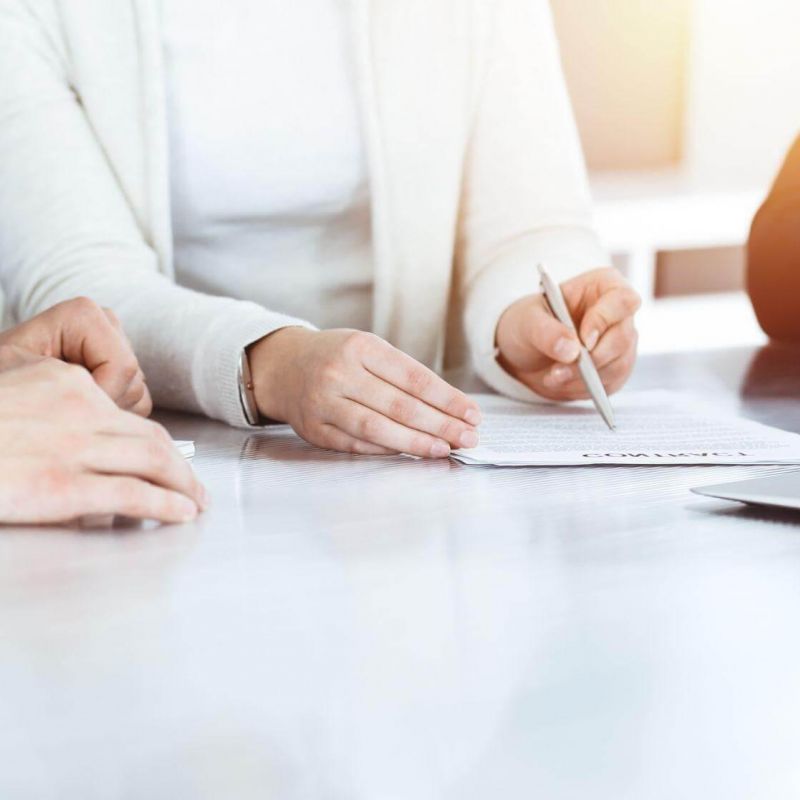 a group of people sitting at a table with a laptop