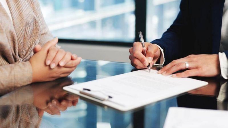 People reviewing documents for wrongful death settlements