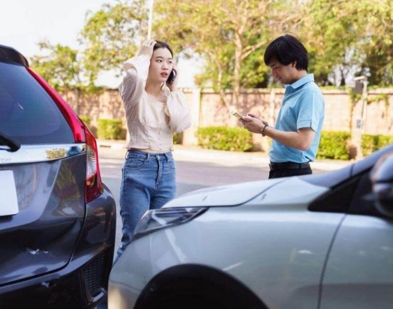 A couple reviewing their parked car after a rideshare