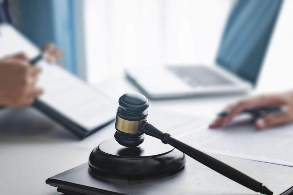 a judge's gaven sitting on top of a desk next to a laptop