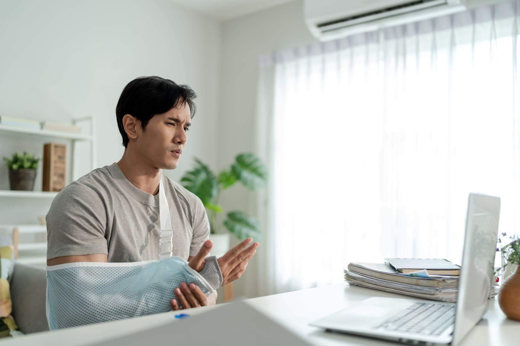a man sitting in front of a laptop computer
