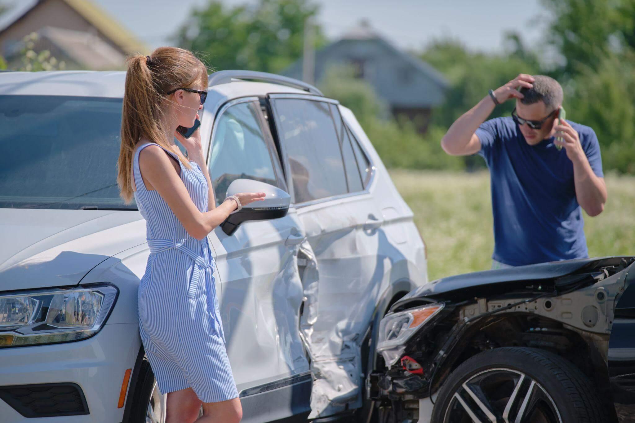 a woman standing next to a white car