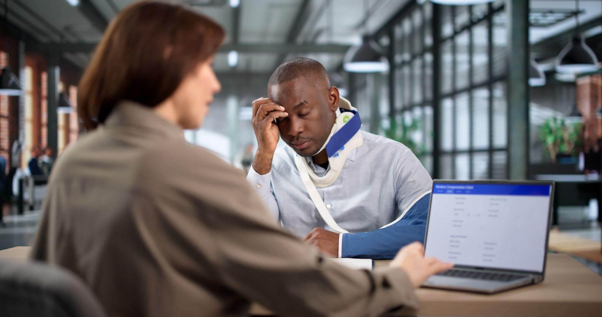 a woman talking on a cell phone next to a man on a laptop