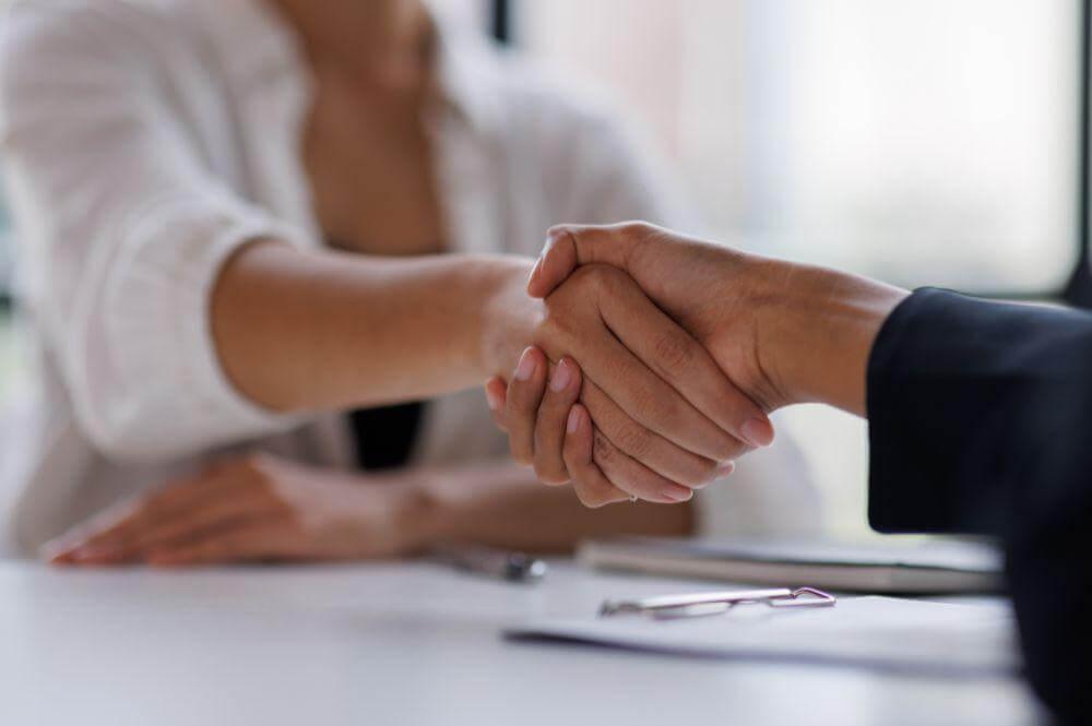a close up of two people shaking hands