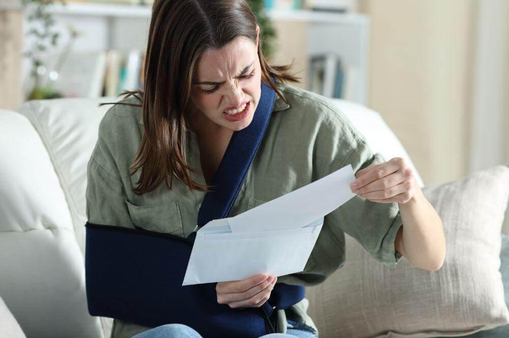 a woman sitting on a couch holding a piece of paper