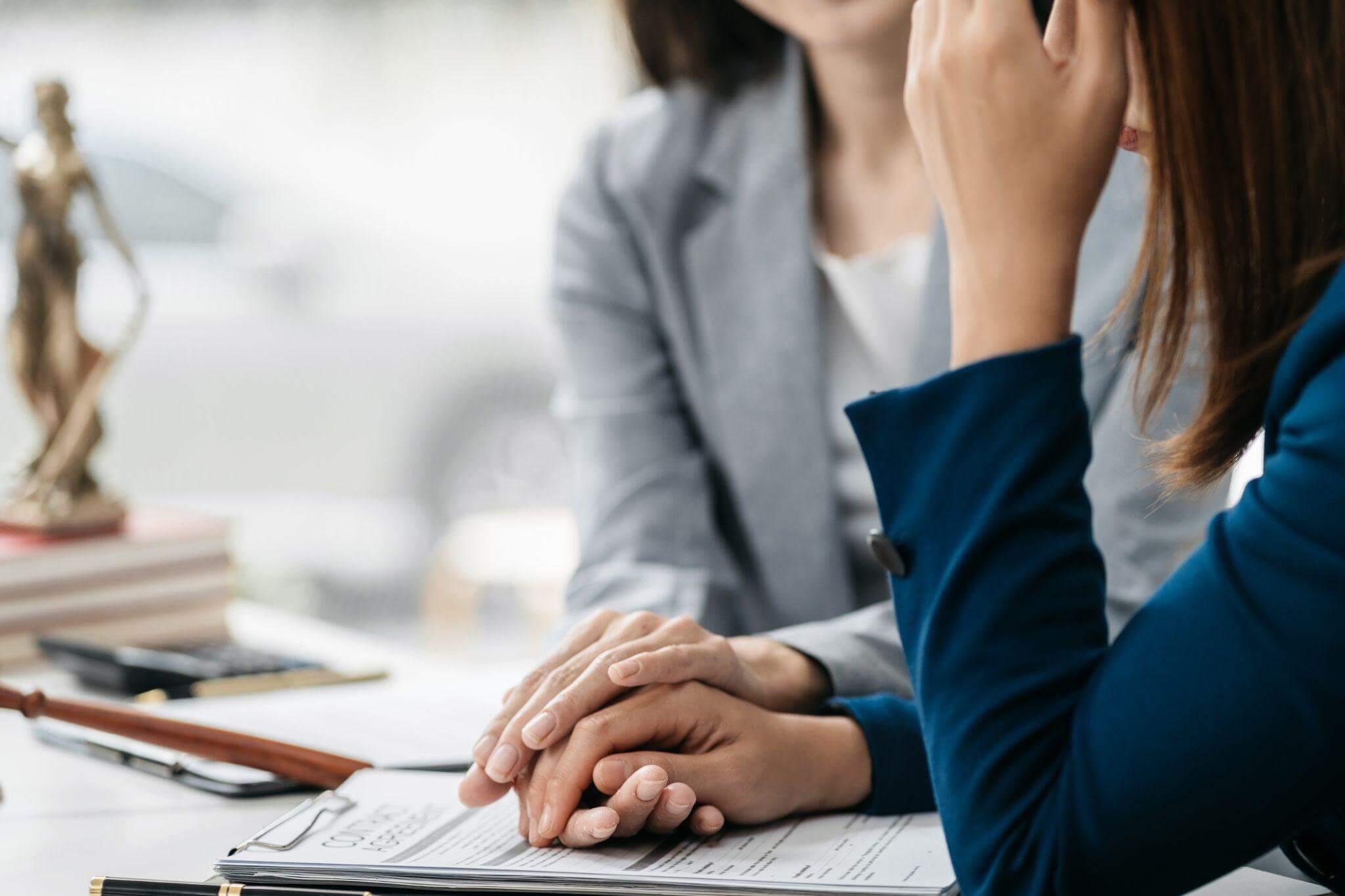 Woman on cell phone at desk, representing client