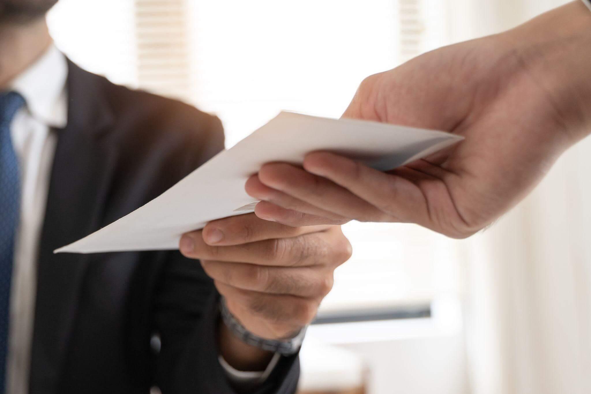 Man in a suit holding settlement papers for wrongful death