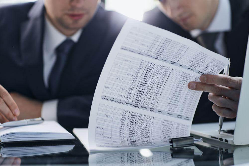 Two men in suits reviewing a legal