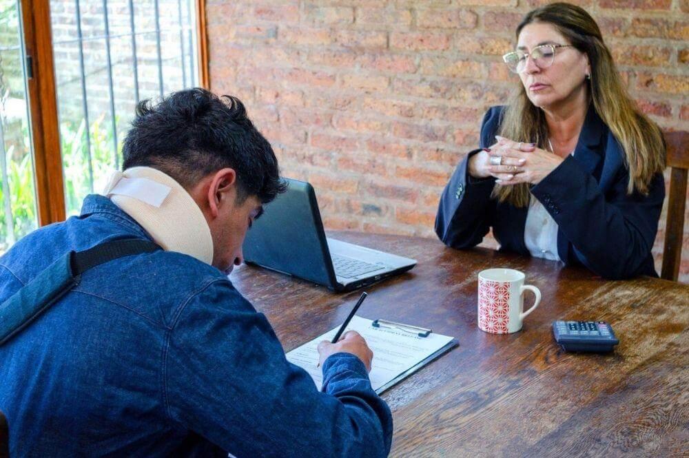 Man and woman reviewing documents with laptops