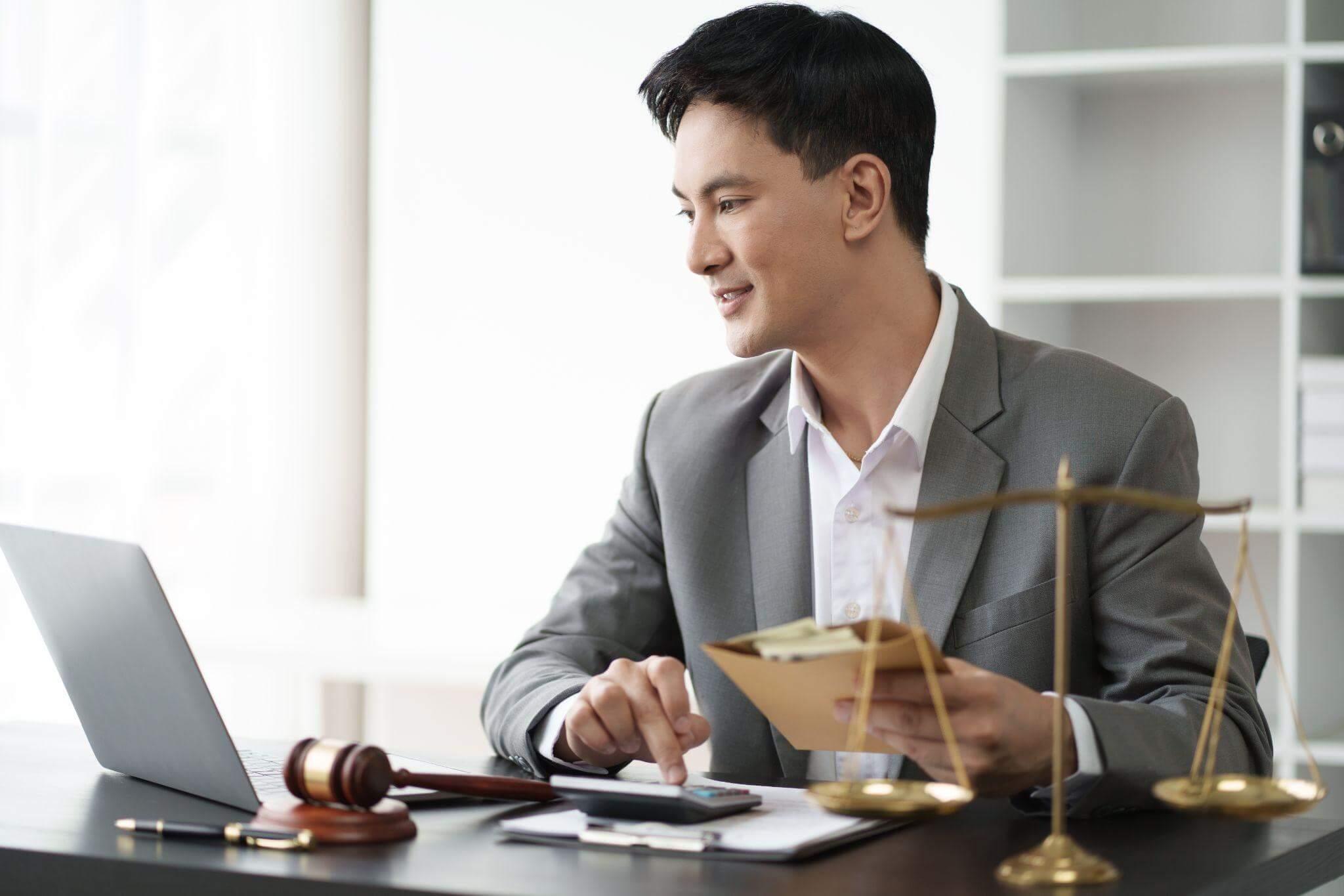Man at laptop reviewing The Woodlands Car Accident Lawyer services