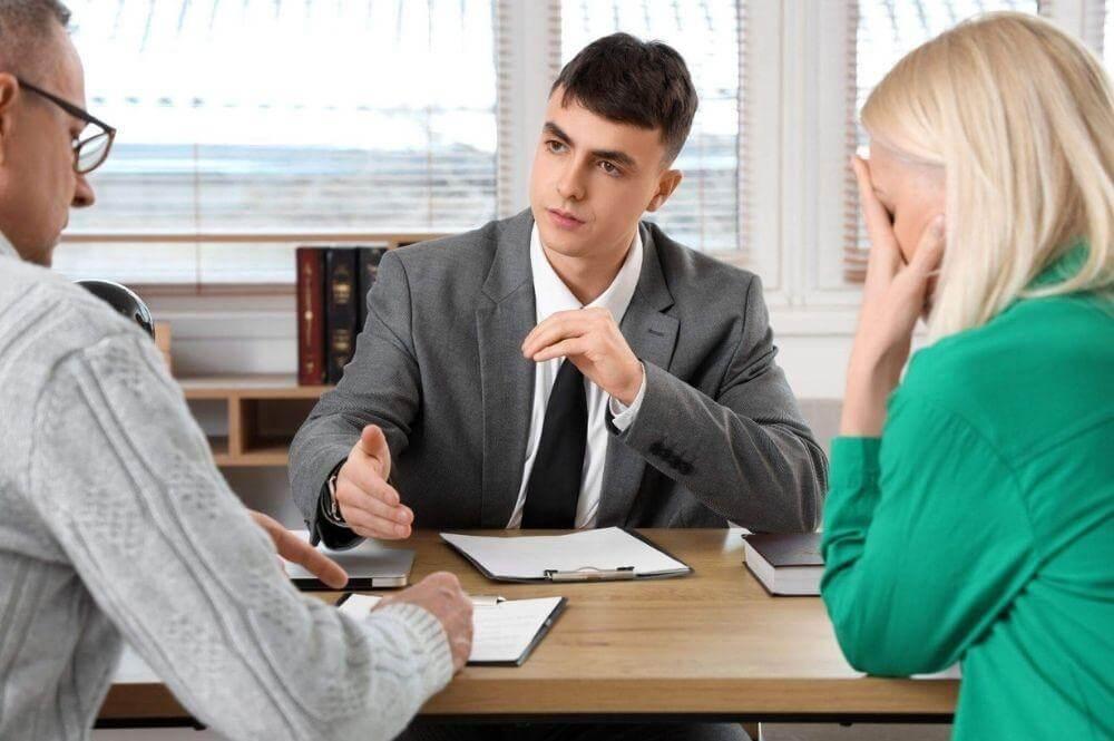 Couple reviewing legal documents at a table for a wrongful