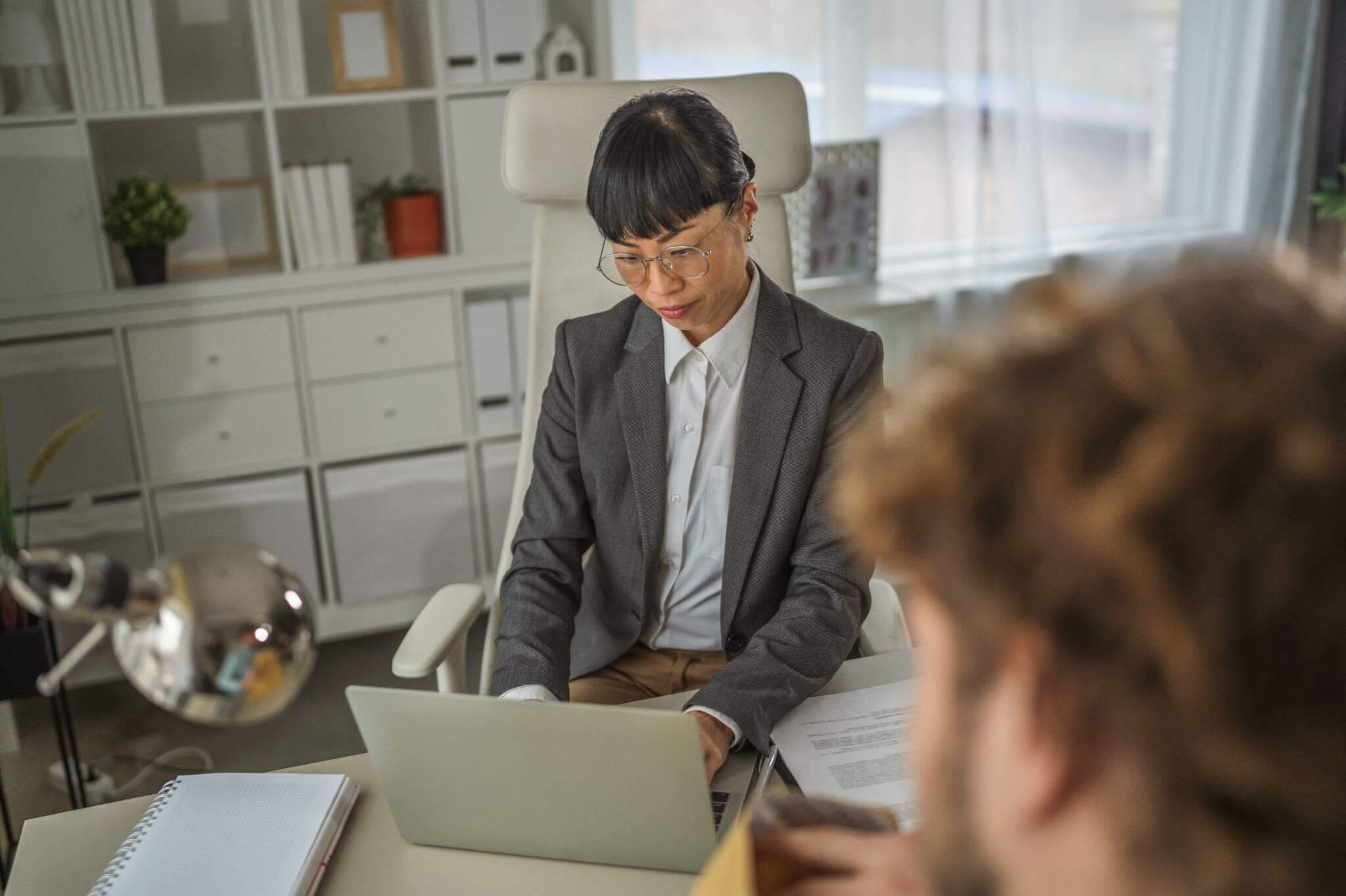 Lawyer at desk using laptop to review a client