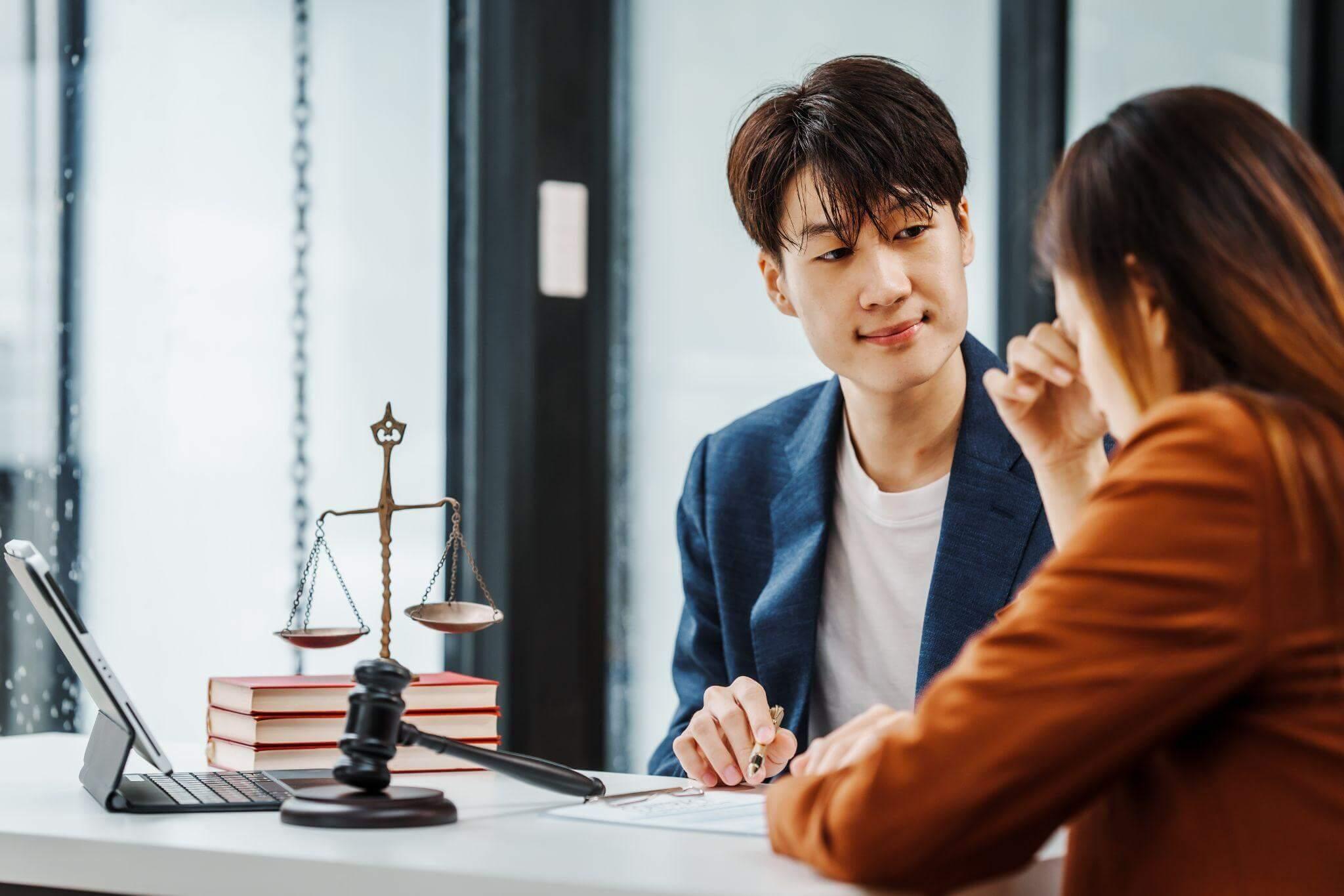 Man and woman at a desk with a laptop,