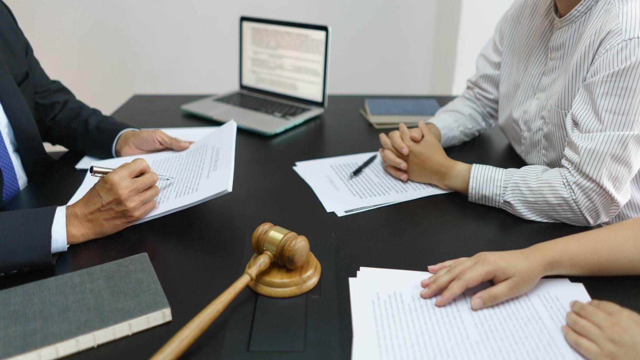 Three people, legal papers, and a judge