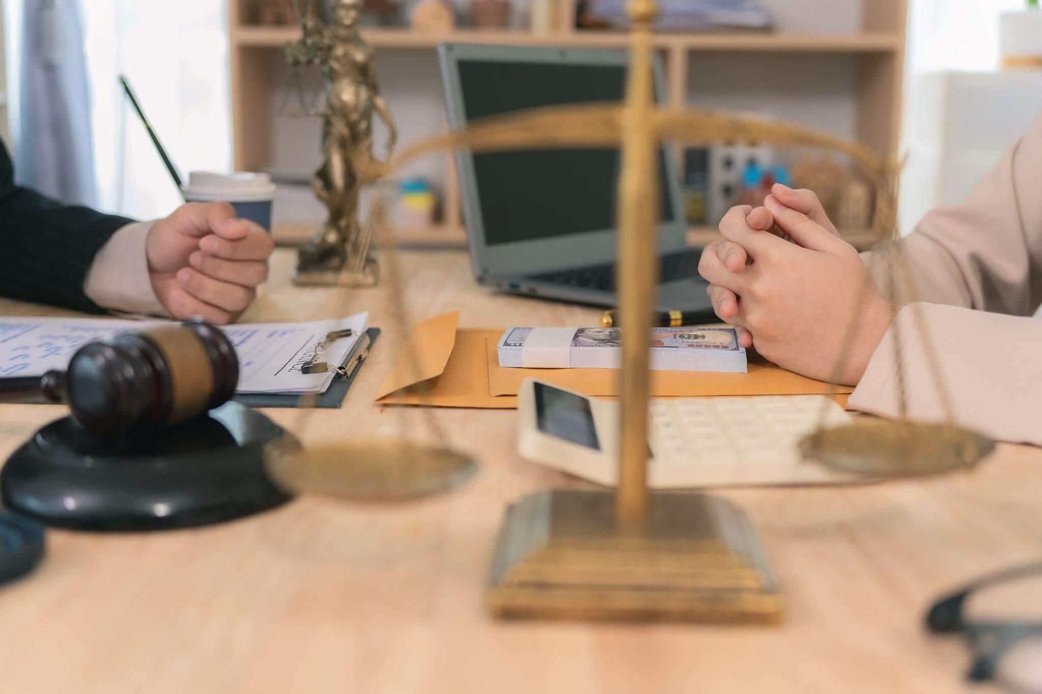 Two people sitting at a table discussing a client