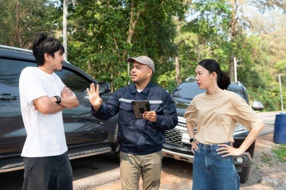 A group of people standing by a car