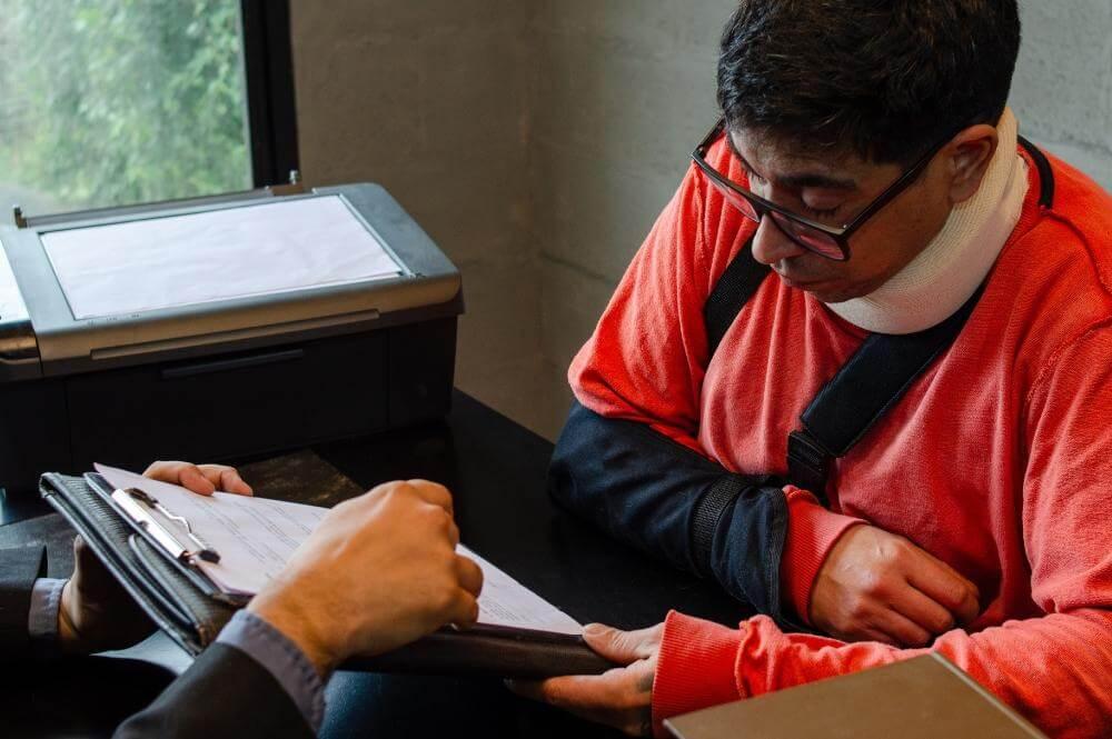 Man reviewing legal documents or client file at a desk