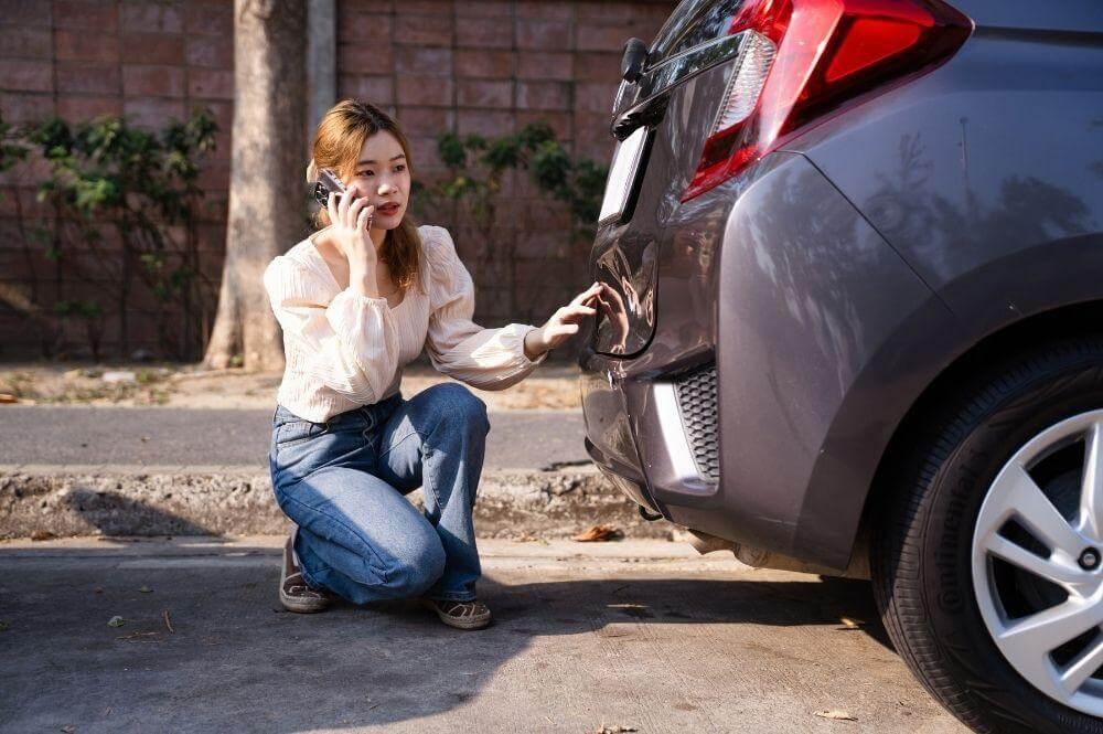 Woman on cell phone after a rideshare accident in